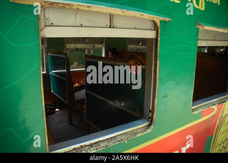 Passengers aboard a train in Yangon, Myanmar. Stock Photo