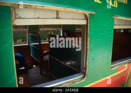 Passengers aboard a train in Yangon, Myanmar. Stock Photo