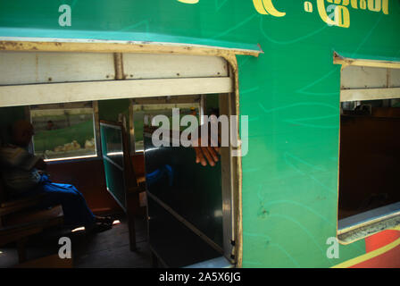 Passengers aboard a train in Yangon, Myanmar. Stock Photo