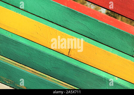 The surface of the nailed boards painted in green, yellow and red. Background picture Stock Photo