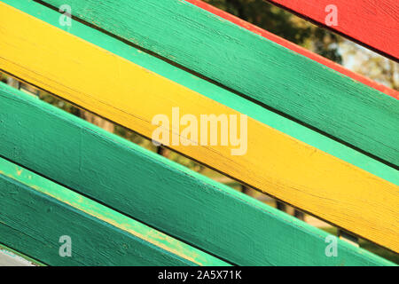 The surface of the nailed boards painted in green, yellow and red. Background picture Stock Photo