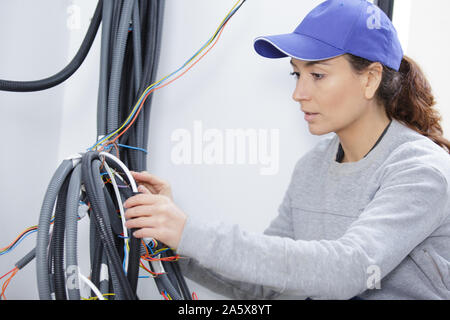 female electrician working with cables Stock Photo