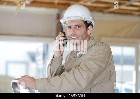 foreman on site using walkie talkie Stock Photo