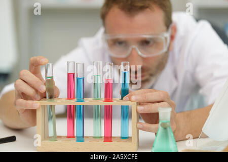 man in laboratory checking test tubes Stock Photo