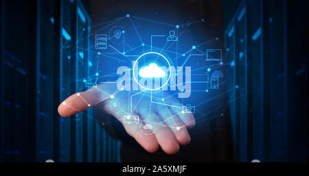 Man holding hologram projection displaying cloud technology symbols Stock Photo