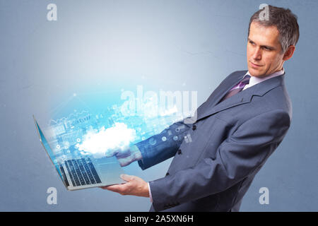 Man holding laptop projecting notifications, symbols and information based on cloud technology system Stock Photo