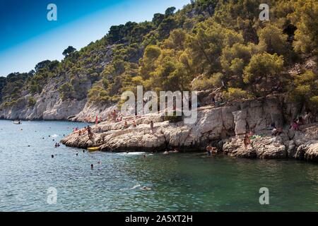 Beach vacationers at the beach in the bay Calanque de Port-Pin, National Park Calanques, Cassis, Departement Bouches-du-Rhone, Provence-Alpes-Cote Stock Photo