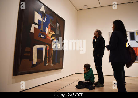 New York, USA. 22nd Oct, 2019. Visitors view the painting Three Musicians by Spanish artist Pablo Picasso in the Museum of Modern Art (MoMA) in Manhattan of New York, the United States, Oct. 22, 2019. MoMA was reopened to the public on Monday after being closed since June 15 for renovation and reorganization of its galleries. Credit: Han Fang/Xinhua/Alamy Live News Stock Photo