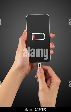 Elegant hand charging cellphone with low battery Stock Photo