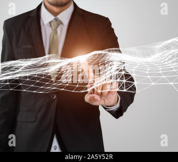 Businessman finger touching flying network connection with copy space on gray background Stock Photo