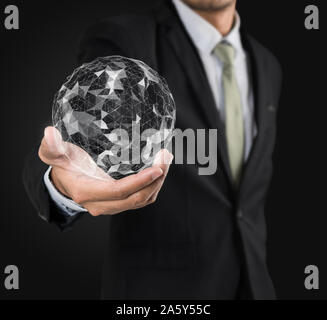 Businessman holding flying earth network connection interface on black background Stock Photo