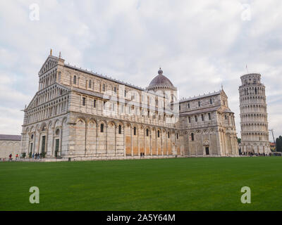 Historical center of Pisa. Cathedral or Duomo di Santa Maria Assunta and famous Leaning Tower or freestanding campanile. View of Piazza dei Miracoli.