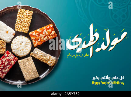 Greeting Card of Traditional Sweets and Arabic Text Saying Bith of The Guider Peace Be Upom Him, Prophet Muhammad Birthday Stock Photo