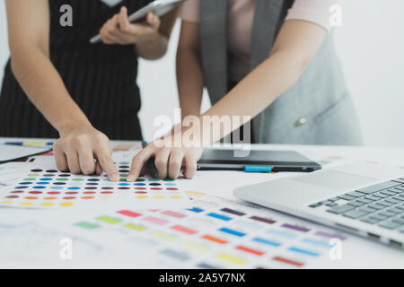 Graphic designer at work. Color swatch samples. Team designer working graphic with color chart and meeting brainstorm for new project. Graphic designe Stock Photo