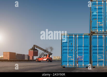 forklift handling container box loading from dock to truck Stock Photo