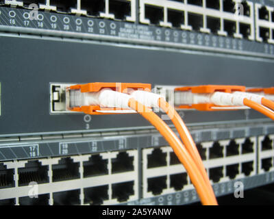 GBIC fiber optic communications switch equipment installed in large data center. Stock Photo