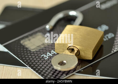 Unlocked padlock with key on credit card - Concept of security and protected paying Stock Photo