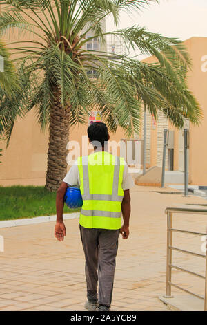 Construction site worker walking for work in Arab country. surveyor, foreman, engineer,industrial worker Stock Photo