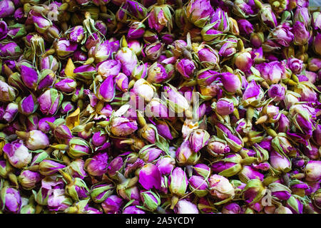 Dried rosebuds background texture closeup. violet rosebud macro close up of heap. Stock Photo