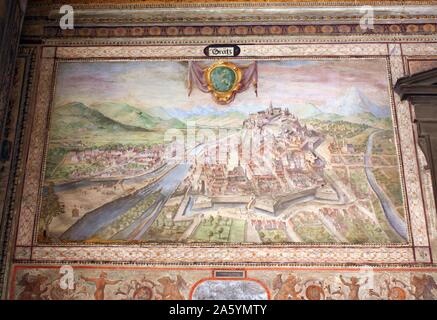 Interior detail from the Palazzo Vecchio, Florence, Italy. A massive, Romanesque fortress-palace designed by the architect Arnolfo di Cambio. Internally, The first courtyard was designed in 1453 by Michelozzo. In the lunettes, high around the courtyard, are crests of the Church and City Guilds. In the centre, the porphyry fountain is by Battista del Tadda. This image shows painted wall detail. Stock Photo