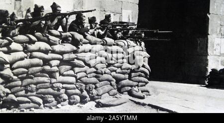 Nationalist soldiers fight behind a barricade during the Spanish Civil War Stock Photo