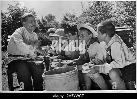 Altai territory, Central Asia, USSR Children on a Soviet collective farm, tasting honey Stock Photo