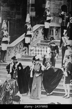 King of England, George V, and his wife Mary of Teck leaving the St. George's Chapel at Windsor Castle after the Prince of Wales (the future Edward VIII) was invested with the Order of the Garter. This event was one of several state functions leading up to George V's coronation on June 22, 1911, at Westminster Abbey. Stock Photo