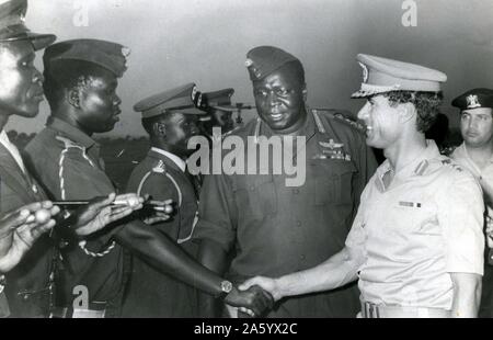 Idi Amin Dada (c. 1925 – 16 August 2003) Centre with Muammar Gaddafi c.?1942 – 2011, Libyan revolutionary who governed Libya as its leader from 1969 to 2011. Amin was President of Uganda, from 1971 to 1979. Stock Photo