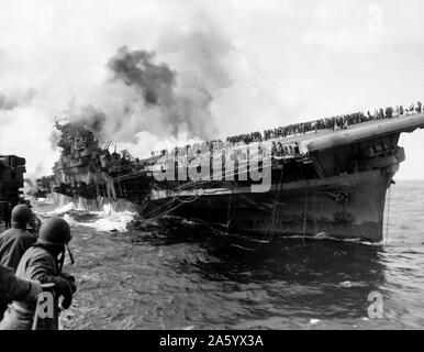 Aircraft carrier USS Franklin (CV-13) attacked by Japanese navy, during World War II, March 19, 1945. Stock Photo
