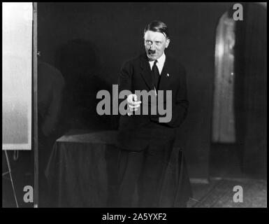 German Nazi leader Adolf Hitler (1889-1945) Austrian-born German politician who was the leader of the Nazi Party, rehearsing a speech in front of the mirror. Dated 1933 Stock Photo