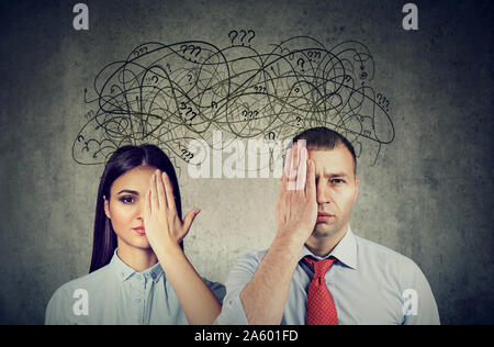 Half blindfolded couple a man and a woman having communication problems and share anxious thoughts Stock Photo