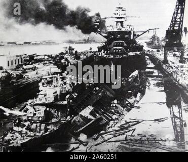 USS Pennsylvania, behind the wreckage of the USS Downes and USS Cassin after the attack on Pearl Harbour. surprise military strike by the Imperial Japanese Navy against the United States naval base at Pearl Harbour, in the United States Territory of Hawaii, on the morning of December 7, 1941. The attack led to the United States' entry into World War II. Stock Photo