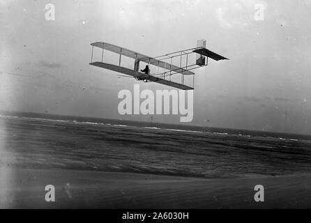 Three-quarter left rear view of glider in flight at Kitty Hawk, North Carolina. Photographed by Wilbur (1867-1912) and Orville (1871-1948) Wright. Stock Photo