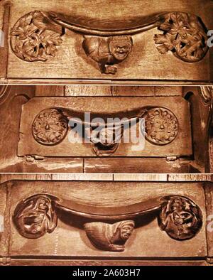 Photographic print showing carved misericords in the choir stalls of Winchester Cathedral, a Church of England cathedral in Winchester. Stock Photo