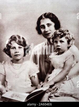 Photograph of Lady Elizabeth (1900-2002) with Princess Elizabeth (1926-) and Princess Margaret (1930-2002) during a visit to the Lord Roberts' Memorial Workshop for Disabled ex-Servicemen. Dated 20th Century Stock Photo
