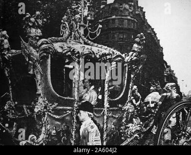 Photograph of the Queen Elizabeth II (1926-) within the Glass Coach, renovated for the Queen's crowning Stock Photo