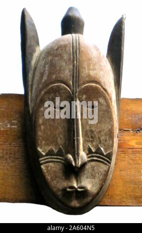 Tribal art: Ngil Mask of the Fang tribe, from Cameroon, West Africa. Ngil society masks, with elongated features, were worn when sentences were handed down by the society. Stock Photo