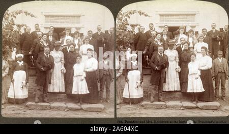 President and Mrs Roosevelt at the home of the President's mother 1903. (African American servants can be seen with the family group). Stock Photo