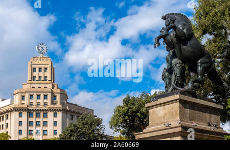 The Wisdom sculpture by Miquel Olse and the BBVA clock tower in Placa de Catalunya, Barcelona, Catalonia, Spain, Europe. Stock Photo