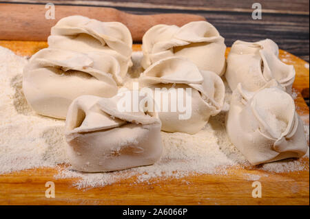 Large manta rays with beef on a wooden Board with flour on the table. Close up Stock Photo