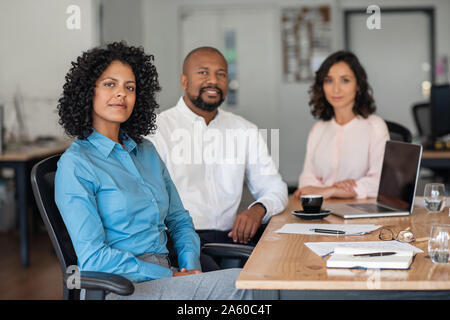 Diverse businesspeople working together at an office table Stock Photo