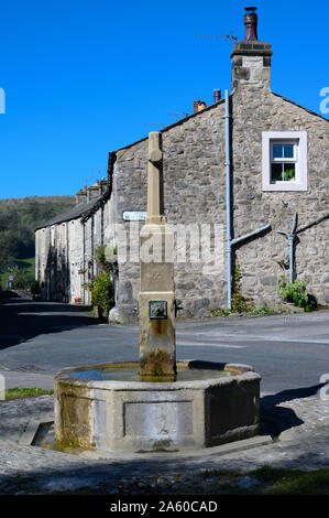 The fountain and war memorial in village of Langcliffe near Settle, North Yorkshire. Stock Photo