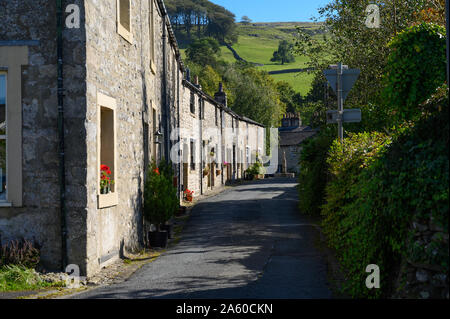 Terraced country cottages on New Street in the village of Langcliffe near Settle, North Yorkshire on a summers day. Stock Photo