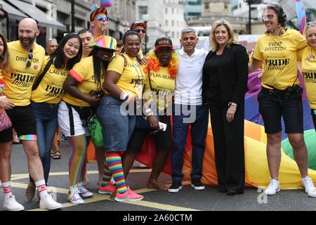 London, UK. 6th July, 2019. Mayor of London, Sadiq Khan and Penny Mordaunt, Secretary of State for Defence posing with participants during the parade.The 50th Pride Parade toke place through Central London with over one million participants. Credit: Pietro Recchia/SOPA Images/ZUMA Wire/Alamy Live News Stock Photo