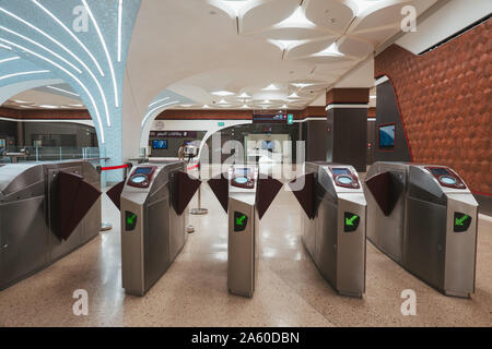 The fare payment gates at a metro station in Doha, Qatar. They operate using a reloadable NFC smart card Stock Photo