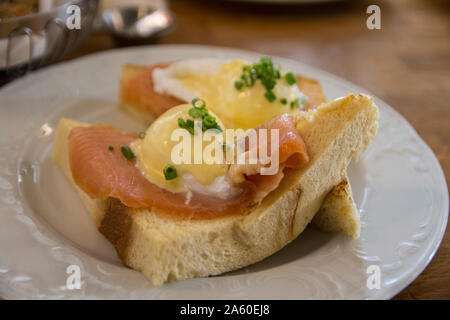 Eggs Benedict Royal, with smoked Salmon, poached eggs, Hollandaise sauce and scallion, over a fresh brioche bread. Stock Photo
