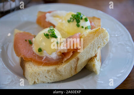 Eggs Benedict Royal, with smoked Salmon, poached eggs, Hollandaise sauce and scallion, over a fresh brioche bread. Stock Photo