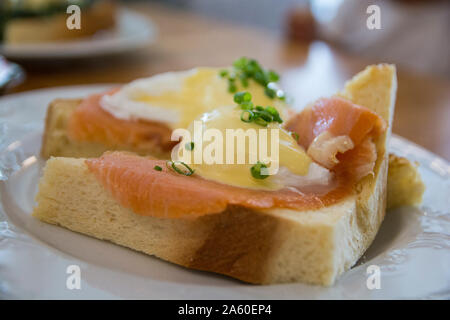 Eggs Benedict Royal, with smoked Salmon, poached eggs, Hollandaise sauce and scallion, over a fresh brioche bread. Stock Photo