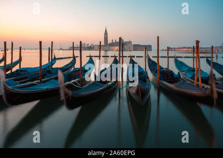 Sunrise in Venice, gondolas and island of St. George view from the square San Marco. Travel.