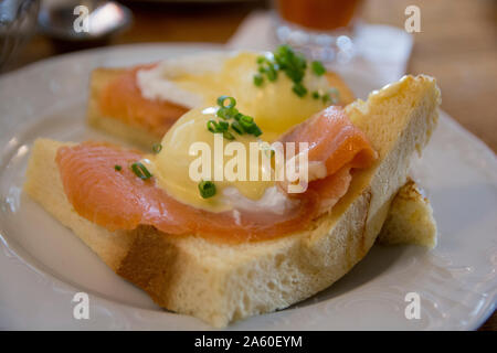 Eggs Benedict Royal, with smoked Salmon, poached eggs, Hollandaise sauce and scallion, over a fresh brioche bread. Stock Photo